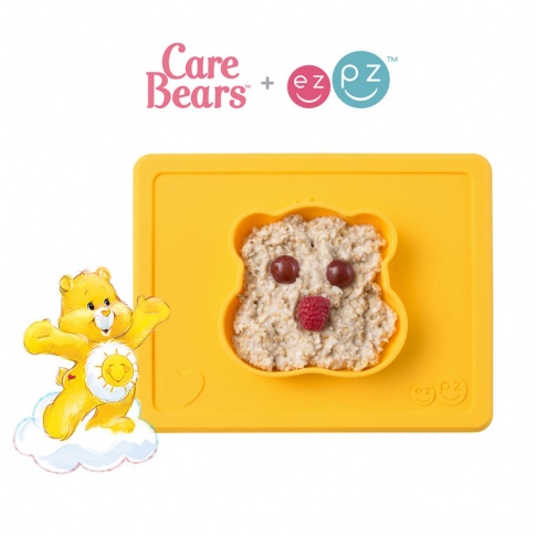 Fotografia, na której jest EZPZ Silikonowa miseczka z podkładką 2w1 Care Bears™ Bowl Misia Słoneczne Serce Funshine Bear żółta